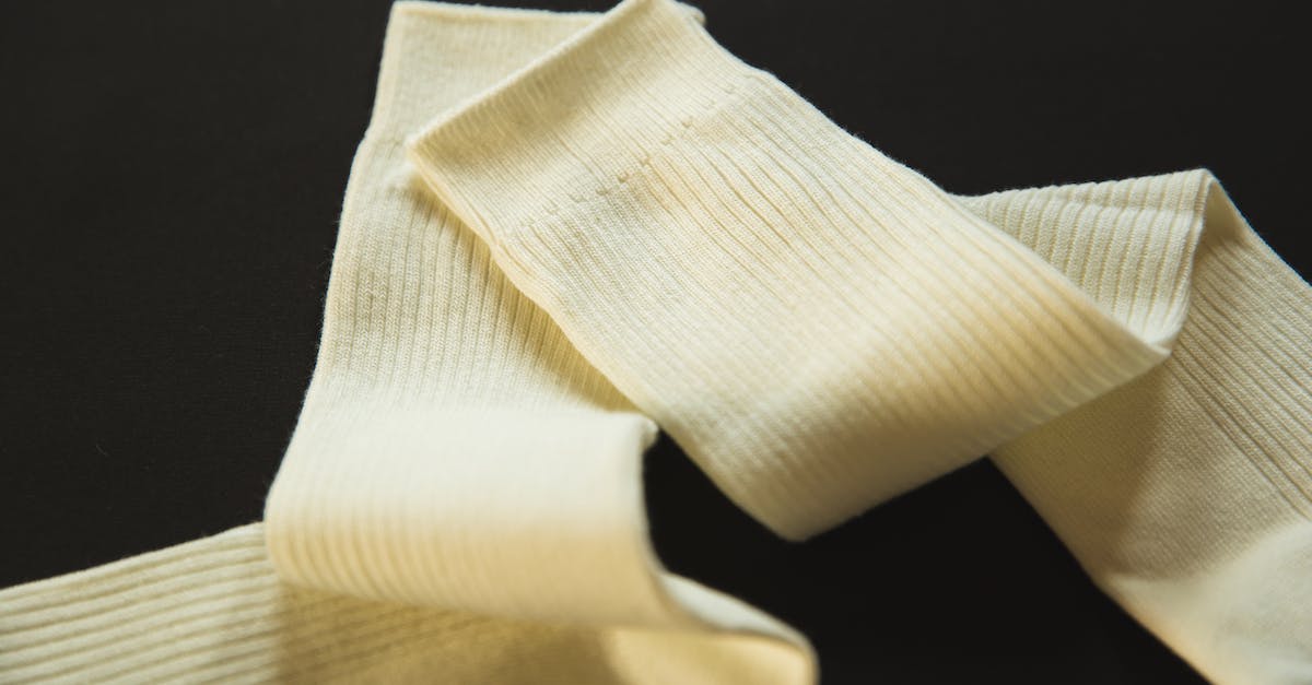 Shoes for long flight - Pair of soft socks on black surface Shoes for long flight - Pair of soft socks on black surface