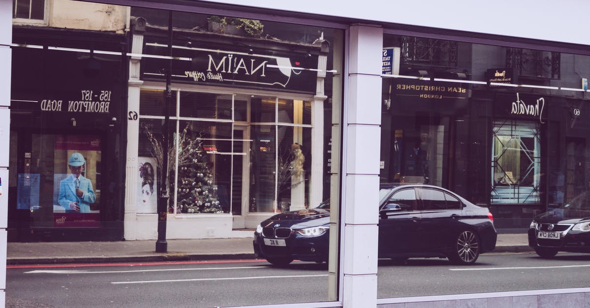 Shops and museums openings during Easter weekend in London - Reflection of Cars on Street Shops and museums openings during Easter weekend in London - Reflection of Cars on Street