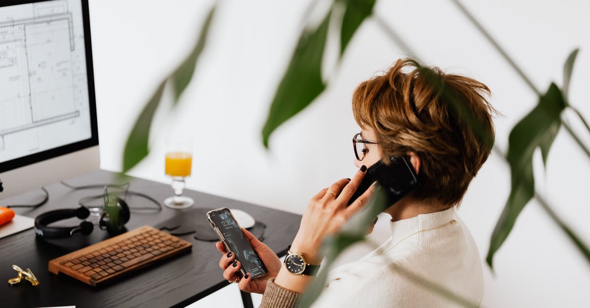 Short connection on LCC at ICN - Busy female talking on smartphone and checking messages during work in contemporary office Short connection on LCC at ICN - Busy female talking on smartphone and checking messages during work in contemporary office