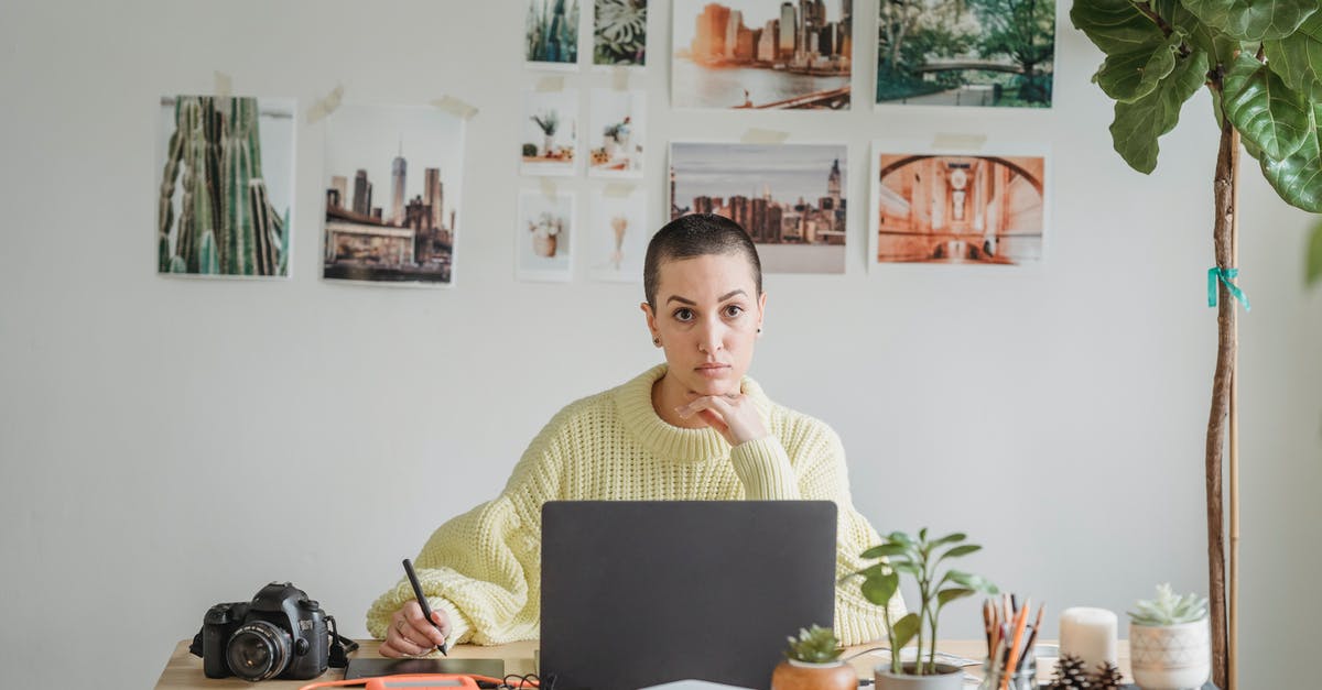 Short term study visa - using property sale as proof of funds - Thoughtful young female in casual wear browsing netbook and writing in copybook while sitting at desk with photo camera and papers