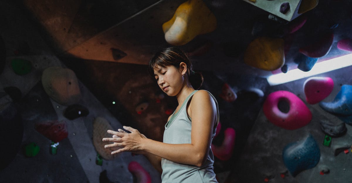 Short training in London - which visa should I apply for? - Focused ethnic climber treats hands with talcum powder