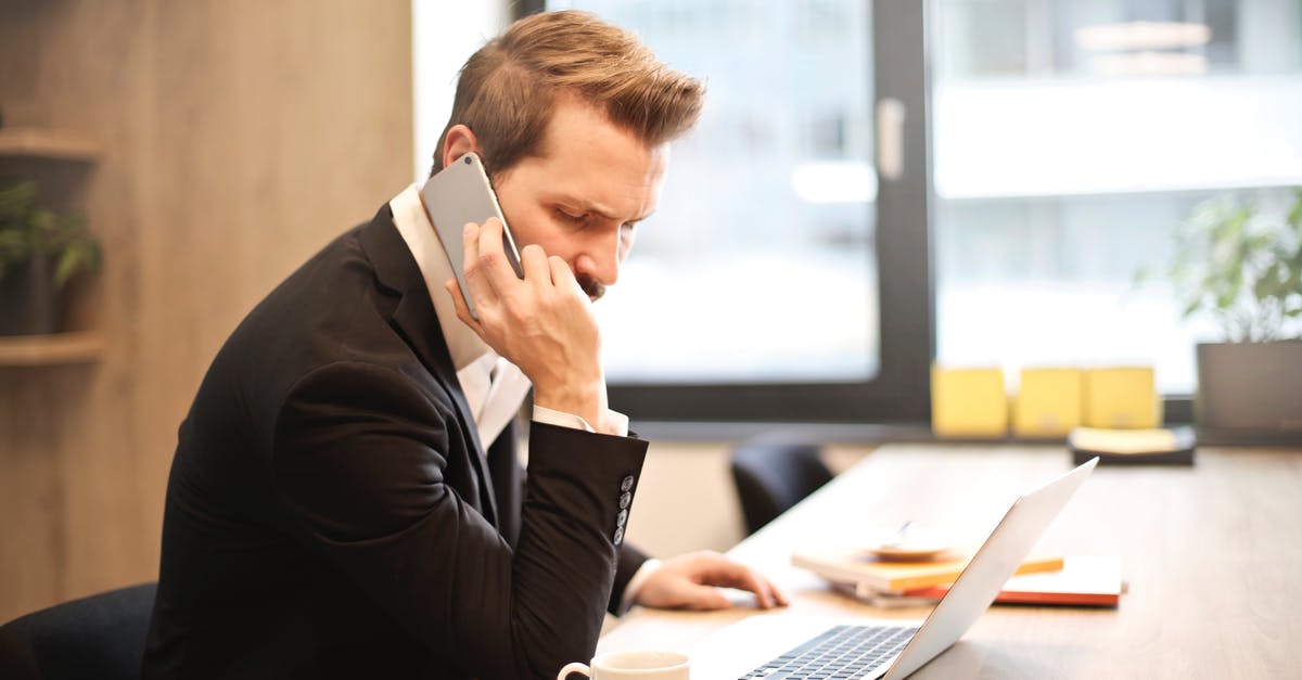 Short-term mobile plans for Japan with voice calling - Man Having a Phone Call In-front of a Laptop Short-term mobile plans for Japan with voice calling - Man Having a Phone Call In-front of a Laptop