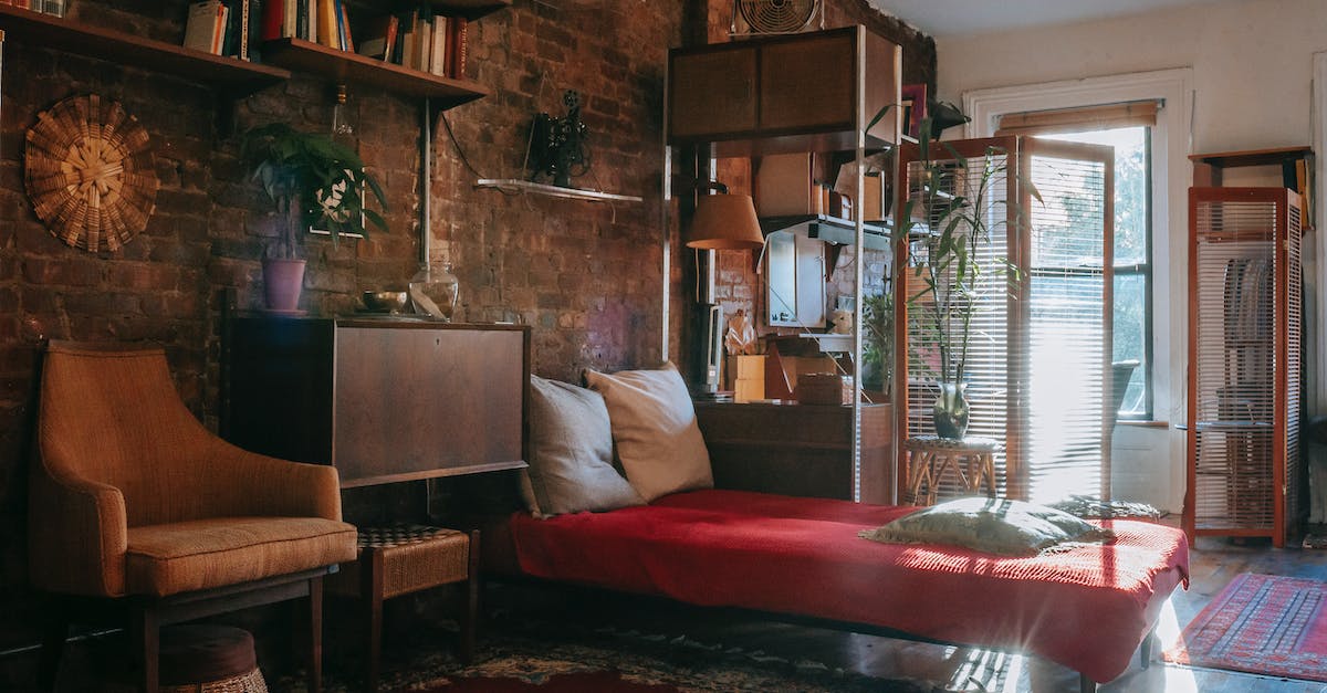 Should I book flights and accommodation before applying for a Russian visa? - Vintage styled bedroom interior with classic wooden furniture and bookshelves decorated weathered brick wall near comfortable bed and armchair Should I book flights and accommodation before applying for a Russian visa? - Vintage styled bedroom interior with classic wooden furniture and bookshelves decorated weathered brick wall near comfortable bed and armchair