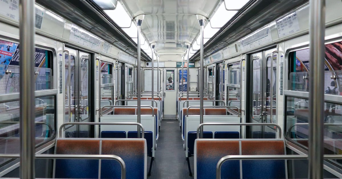 Should I book Thailand Rail tickets online (pre-trip) or at the station when I arrive? - Empty illuminated subway train with seats and metal railings stopped on platform at station Should I book Thailand Rail tickets online (pre-trip) or at the station when I arrive? - Empty illuminated subway train with seats and metal railings stopped on platform at station