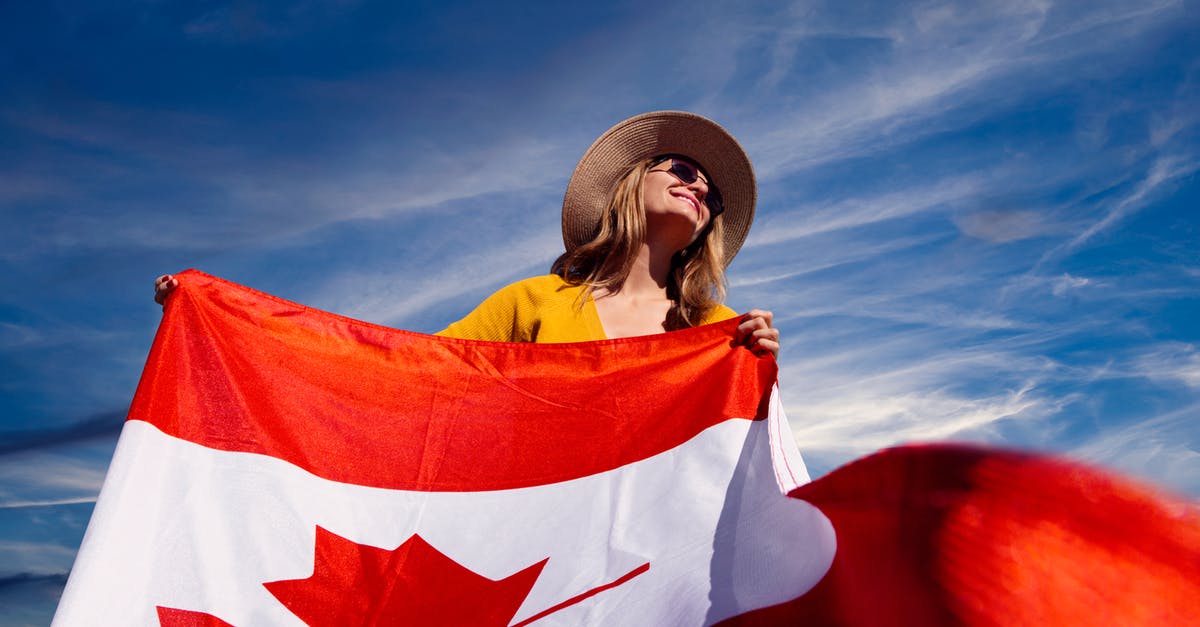 Should I change most of my money in my home country or in the destination country? baht to canadian dollars....change in thailand or canada - A Photograph of a Woman Holding a Canadian Flag Should I change most of my money in my home country or in the destination country? baht to canadian dollars....change in thailand or canada - A Photograph of a Woman Holding a Canadian Flag