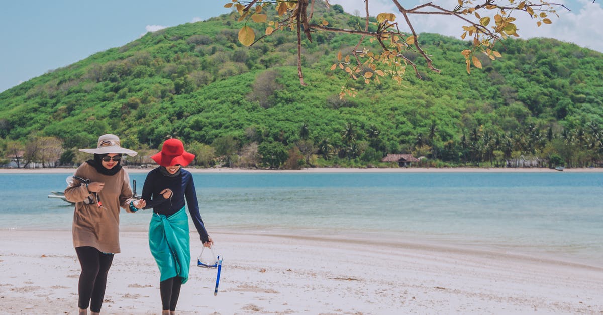 Should I get vaccination before travelling to Lombok (Indonesia) - Photo of Two Women Walking on Seashore Should I get vaccination before travelling to Lombok (Indonesia) - Photo of Two Women Walking on Seashore