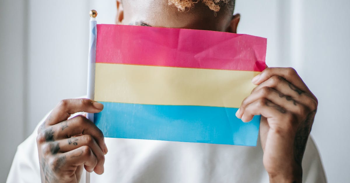 Should I just cover my forearm tattoo in Japan - Black woman with LGBT flag Should I just cover my forearm tattoo in Japan - Black woman with LGBT flag