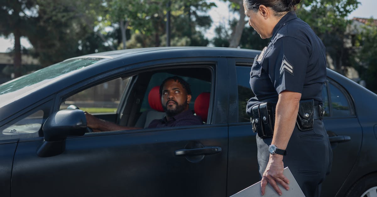 Should I pay my rental car company a speeding and toll ticket in Canada? [closed] - Man Driving While Looking at the Policewoman 