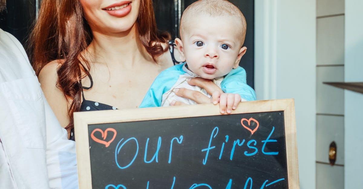 Should I purchase Baby Carseat for 6 months baby? [closed] - Woman Carrying a Baby Holding a Small Blackboard