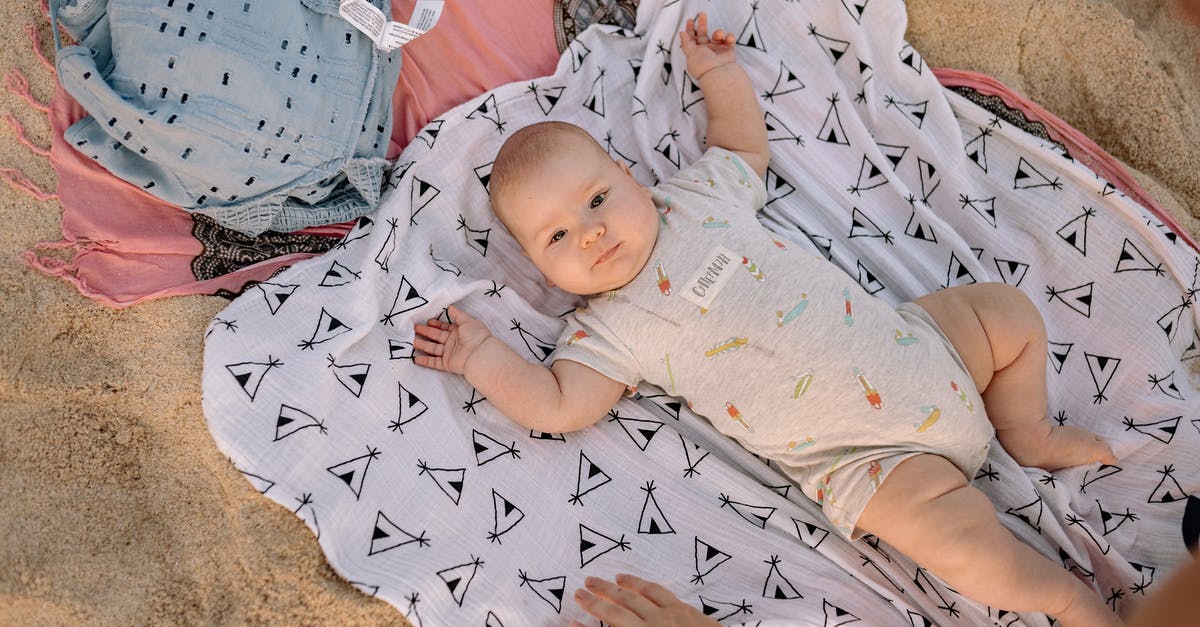 Should I purchase Baby Carseat for 6 months baby? [closed] - Baby in White and Blue Onesie Lying on Brown Carpet