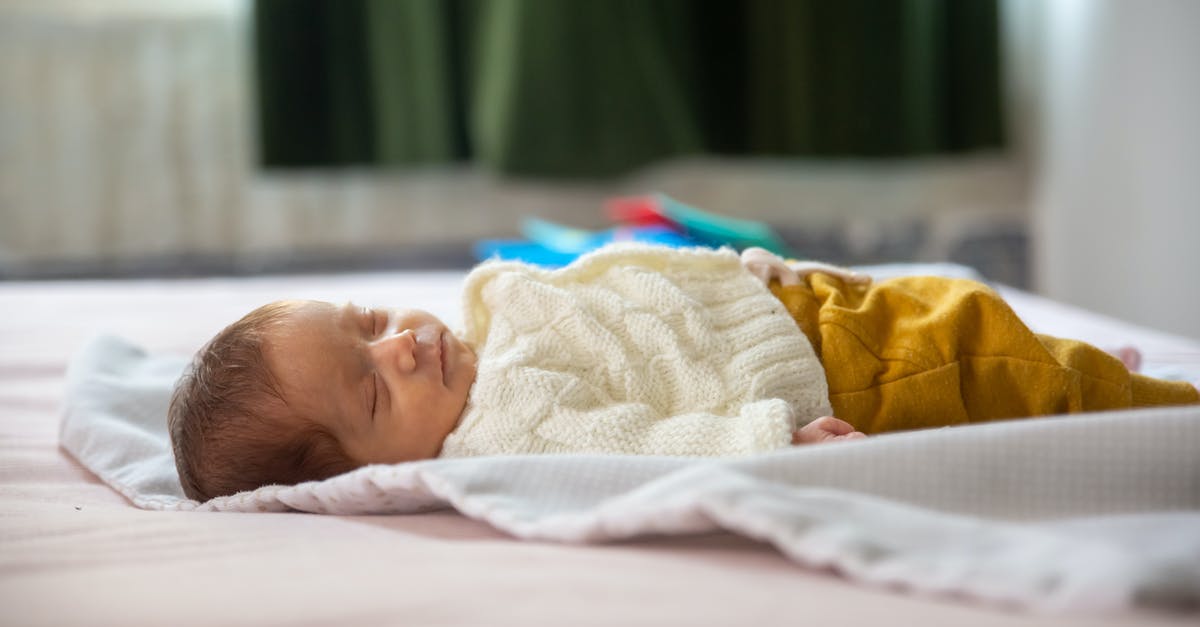 Should I purchase Baby Carseat for 6 months baby? [closed] - Baby Lying on White Bed