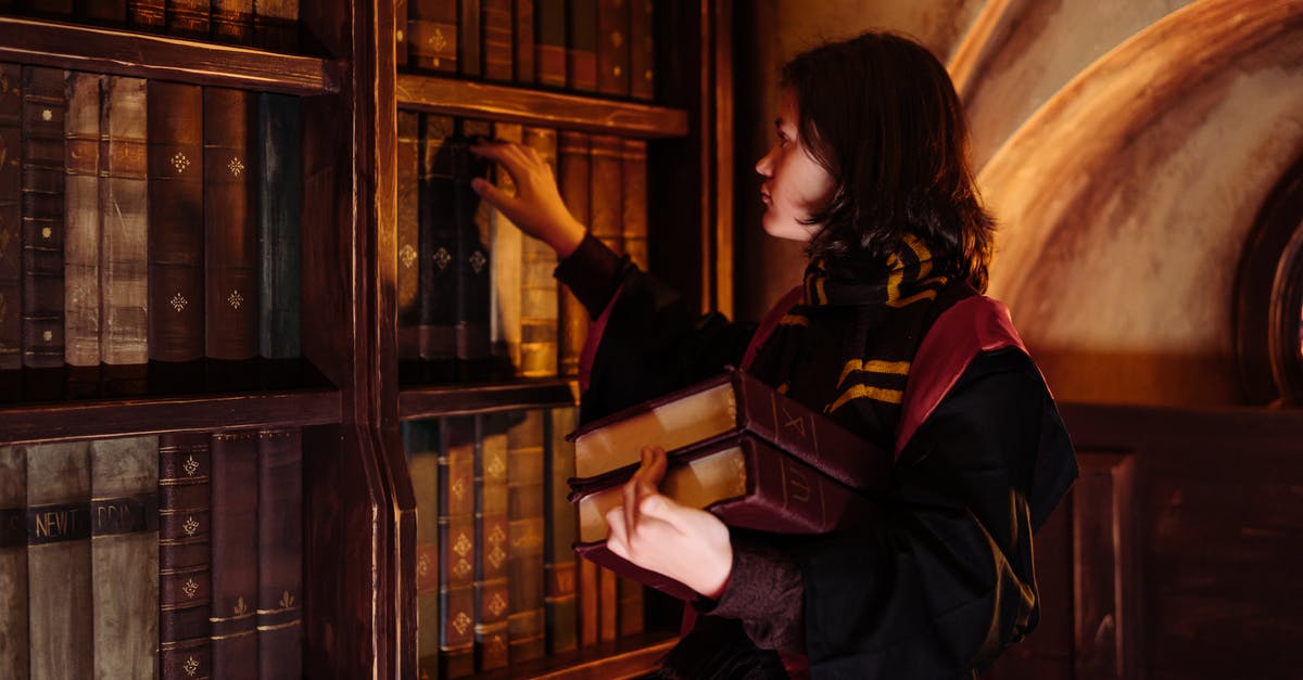Should I put books in carry-on or checked luggage? - A Person Looking at the Book Shelves Should I put books in carry-on or checked luggage? - A Person Looking at the Book Shelves