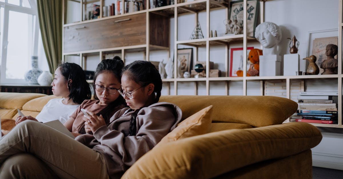 Should I select 'I live with family' in UK visit visa application since I live with my sister? - Girls Sitting on the Couch while Looking at the Phone Should I select 'I live with family' in UK visit visa application since I live with my sister? - Girls Sitting on the Couch while Looking at the Phone