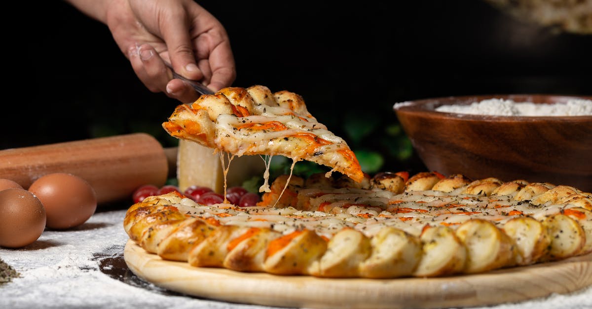 Should people with dual nationality obtain and renew both passports? [closed] - Person Holding Pizza on Wooden board