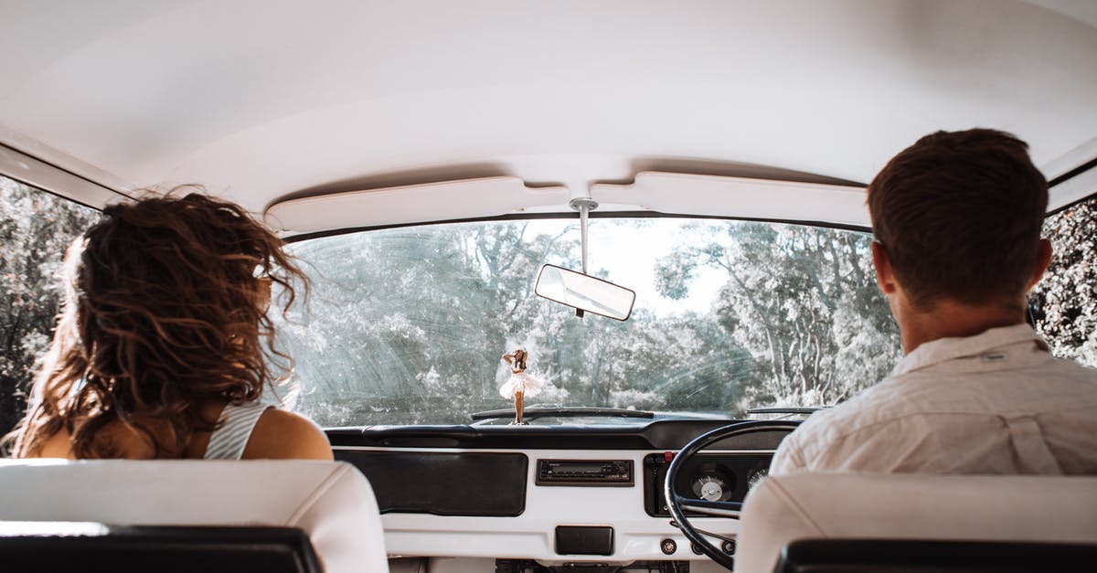 Show the time at milestones for a car travel route - Couple travelling in car together Show the time at milestones for a car travel route - Couple travelling in car together
