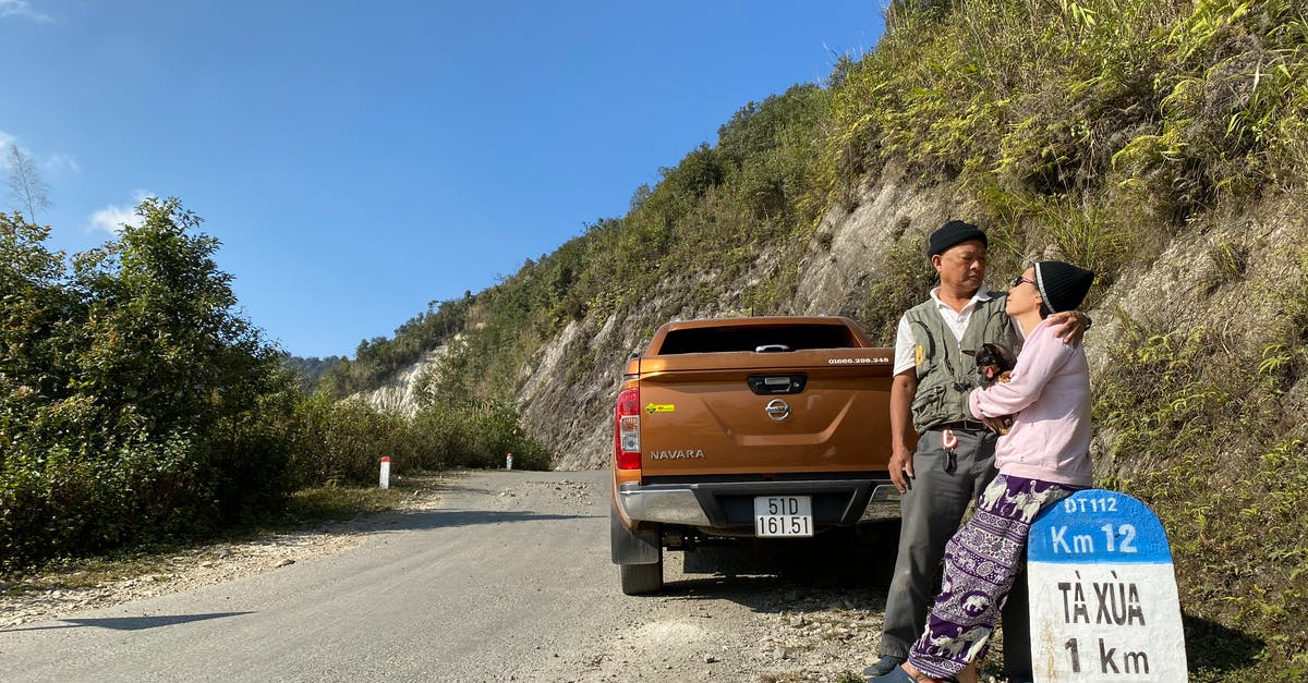 Shower at a truck stop for a couple travelling in car - Old Asian couple traveling together on truck