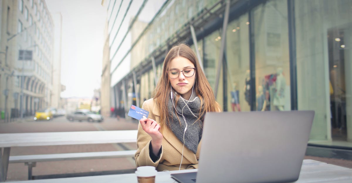 SIM card in New Zealand with unlimited internet access [duplicate] - Woman in Brown Coat Holding a Bank Card