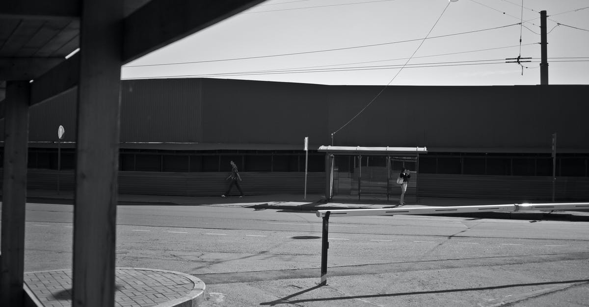 Single-entry Schengen visa on cruise that stops outside of the Schengen area - Black and white of empty road against bus stop and building placed in city in sunny day Single-entry Schengen visa on cruise that stops outside of the Schengen area - Black and white of empty road against bus stop and building placed in city in sunny day