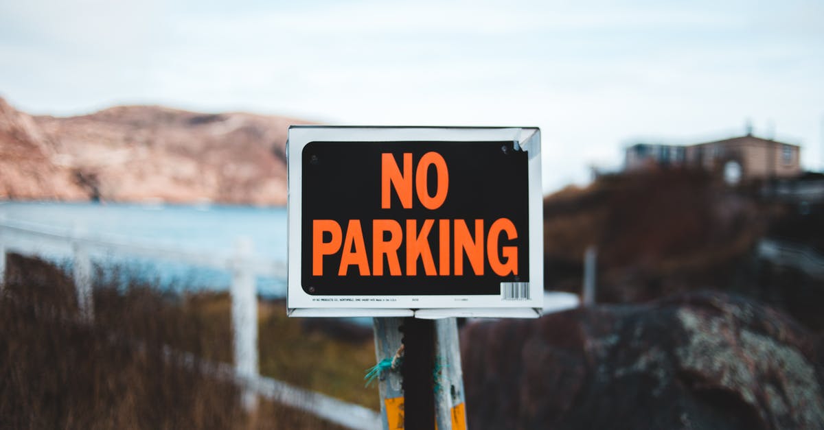 Single-entry Schengen visa on cruise that stops outside of the Schengen area - Signboard No parking placed in nature against blue lake Single-entry Schengen visa on cruise that stops outside of the Schengen area - Signboard No parking placed in nature against blue lake