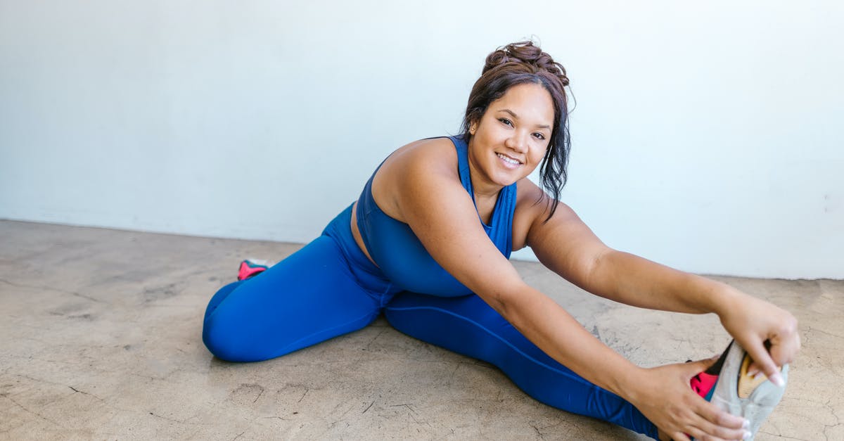 Size 26 curvy girl. Flying across country with Delta. Will I fit into the seat? - Woman in Blue Tank Top and Blue Leggings Sitting on Brown Sand