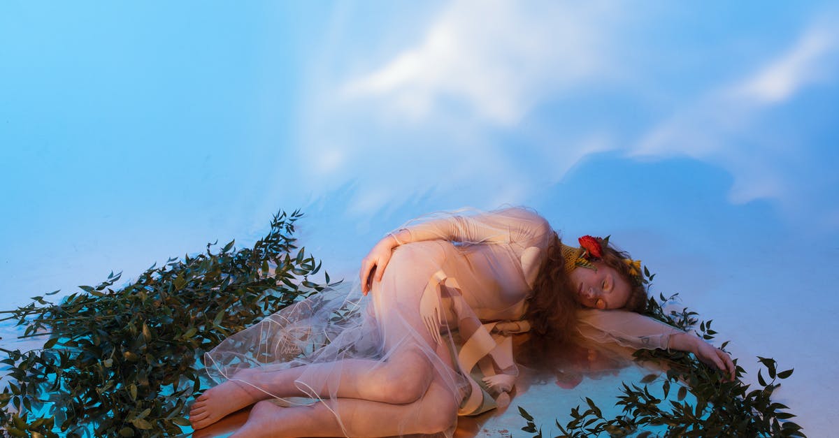 Sleeping at Toronto Pearson YYZ airside? - Woman in White Dress Lying on Green Grass Sleeping at Toronto Pearson YYZ airside? - Woman in White Dress Lying on Green Grass
