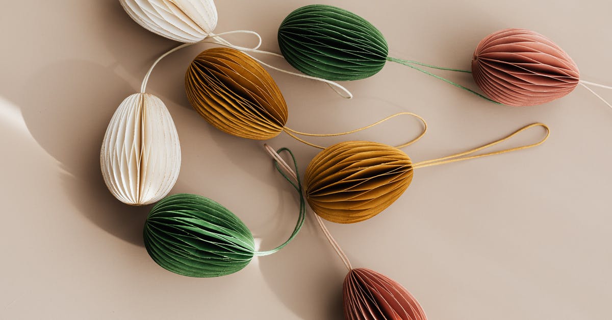 Small Diwali gifts, from an overseas visitor in India during the festive period? - From above of pastel colorful crafts made of cardboard with thin cords for pendant souvenir scattered on beige table at sunny day