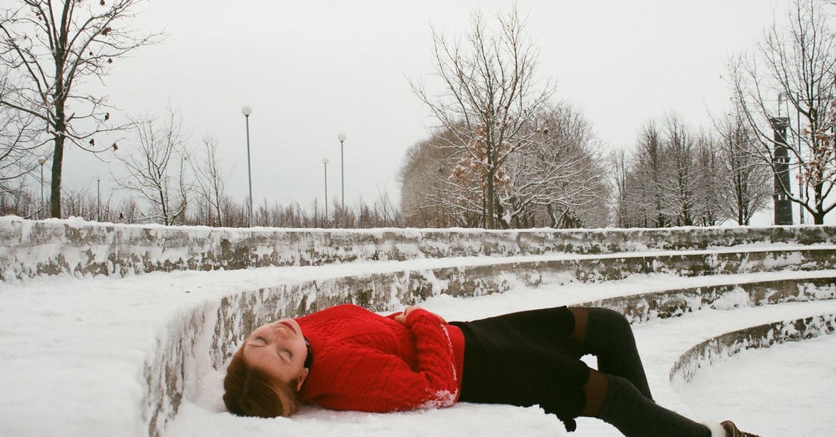 Snow fall this Christmas near Hong Kong? - Woman Wearing Red Sweater Lying on Snow Covered Ground Snow fall this Christmas near Hong Kong? - Woman Wearing Red Sweater Lying on Snow Covered Ground