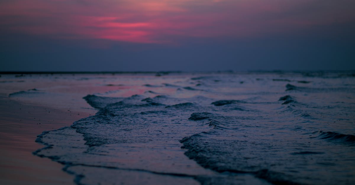 Snowfall at sea level closest to the equator? [closed] - Close-up of Waves on Beach at Sunset