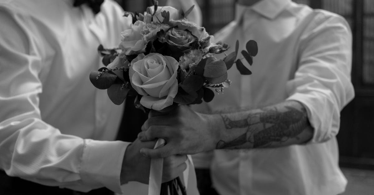 Someone or somewhere to get Tebori Tattoo in/around Osaka [closed] - Grayscale Photo of Man Holding Bouquet of Flowers