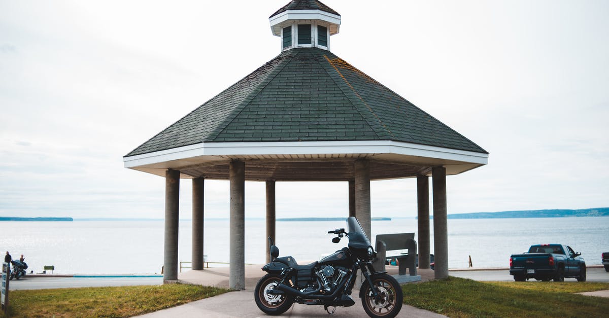 South Lake Tahoe travel by Public transport - Cloudless clear sky over black classical motorcycle parked on road to tall rotunda on shore of big lake South Lake Tahoe travel by Public transport - Cloudless clear sky over black classical motorcycle parked on road to tall rotunda on shore of big lake