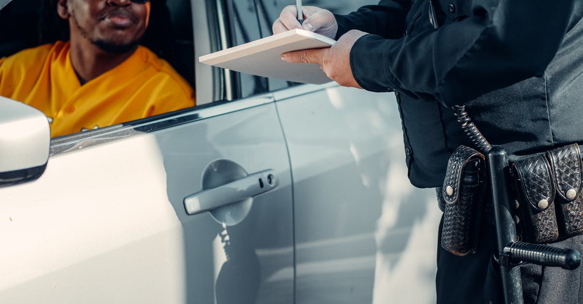 Speeding ticket in Germany [closed] - Man Looking at the Police Officer Writing 