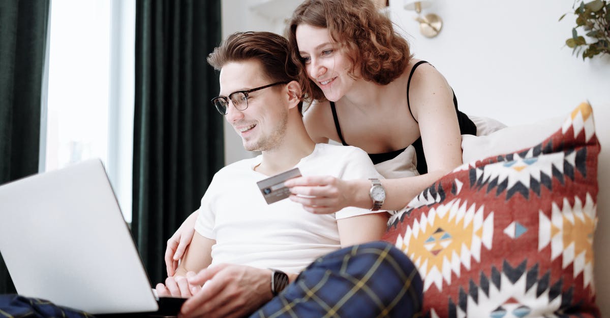 Spending pesos at IAH - Man and Woman Shopping Online Spending pesos at IAH - Man and Woman Shopping Online