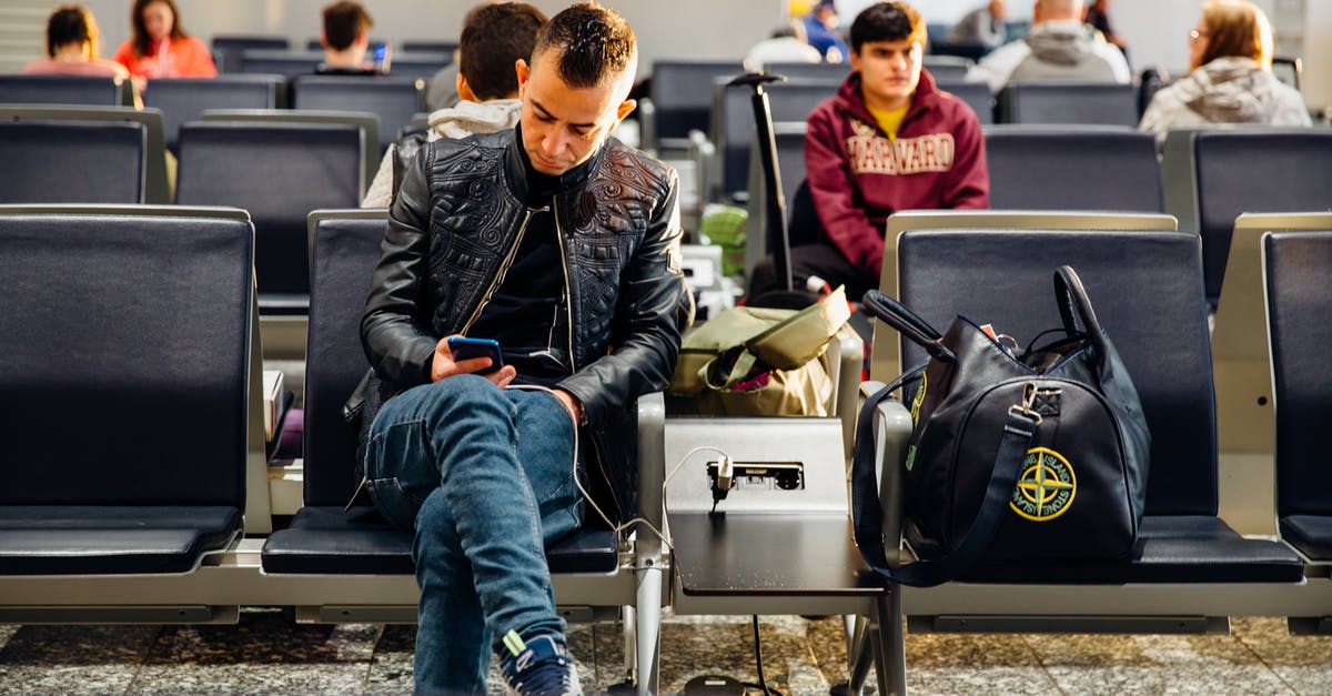 Stansted Airport USB Charging Outlets - Man in Black Leather Jacket Sitting on Chair Stansted Airport USB Charging Outlets - Man in Black Leather Jacket Sitting on Chair