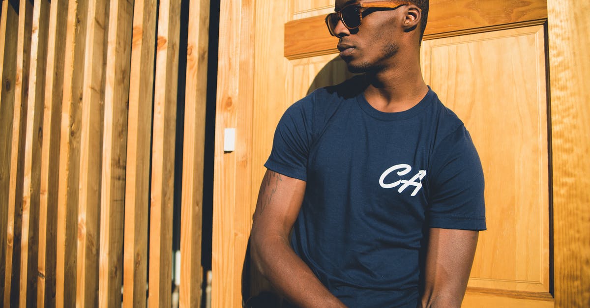 Stansted Express. Do I actually need to print my e-ticket? - Man in Blue T-shirt Leaning Against Brown Wooden Wall Stansted Express. Do I actually need to print my e-ticket? - Man in Blue T-shirt Leaning Against Brown Wooden Wall