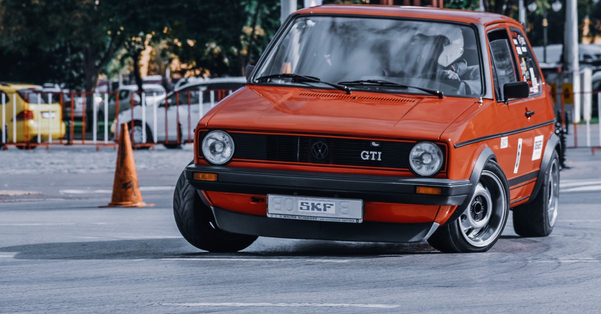 Stavropol City, surrounding area - Safety - Unrecognizable person in protective helmet driving red car of 90s on street in daytime Stavropol City, surrounding area - Safety - Unrecognizable person in protective helmet driving red car of 90s on street in daytime