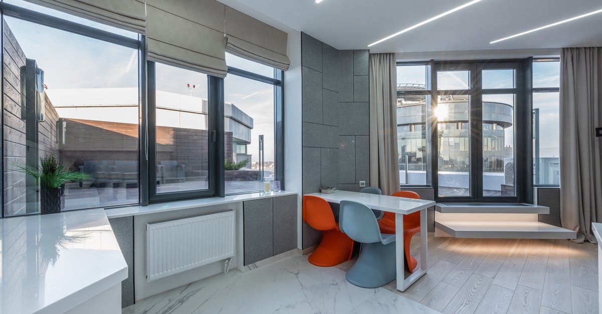 Staying in Australia for a day on transit visa and returning to New Zealand - Interior of modern home with table and chairs near windows Staying in Australia for a day on transit visa and returning to New Zealand - Interior of modern home with table and chairs near windows
