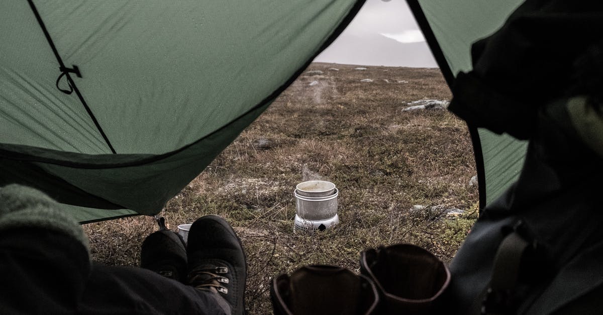 Staying in Canada beyond eTA and passport expiration [duplicate] - A Person Wearing Black Shoes Staying Inside the Tent