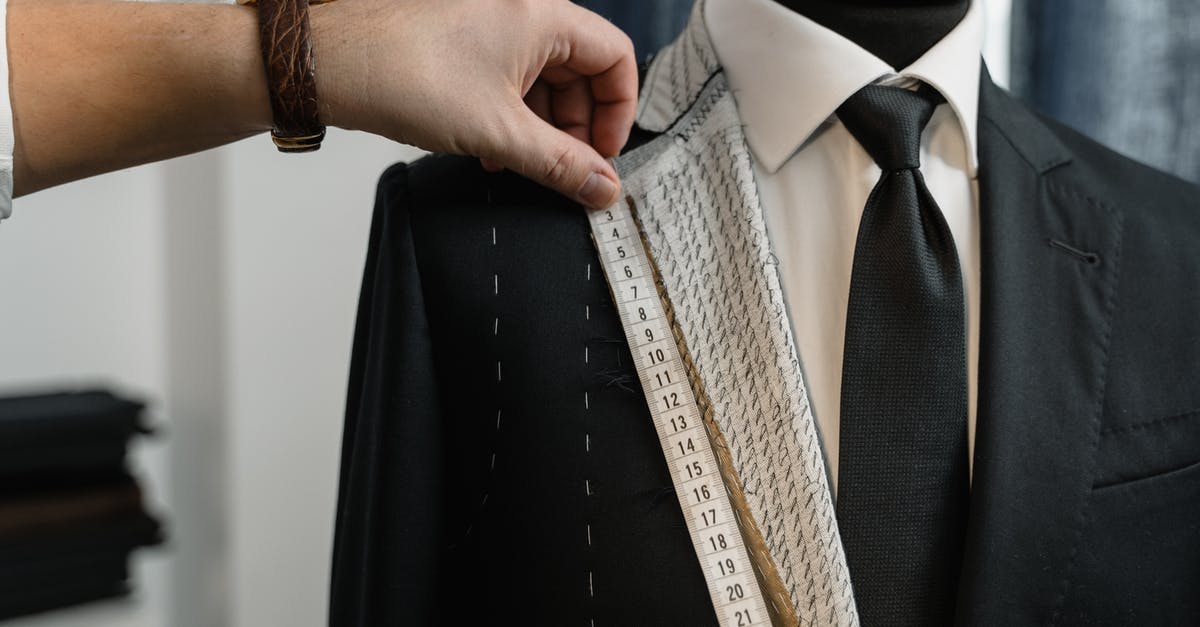 Stitching two Confirmation Numbers on United - Man in Black Suit Jacket Holding Brown Necktie Stitching two Confirmation Numbers on United - Man in Black Suit Jacket Holding Brown Necktie