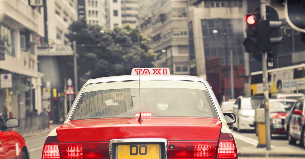 Stop in Hong Kong 3:30 hrs [duplicate] - Red and White Taxi on Road