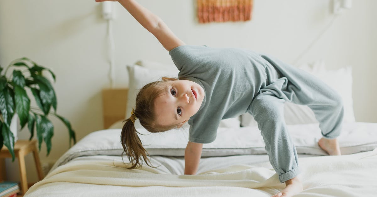 Stopover in Heathrow, do I have to secure any kind of UK visa [duplicate] - Adorable little girl having fun on bed at home