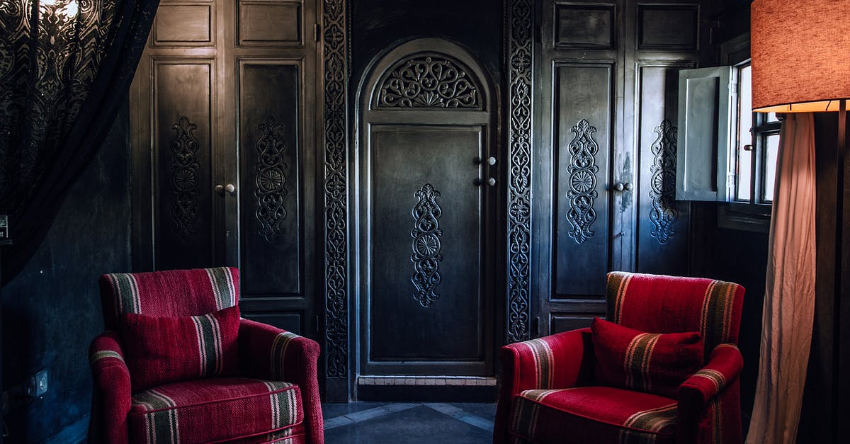 Storage of home SIM while abroad - Interior of old fashioned room with ornamental wooden wardrobe and cozy furniture in apartment Storage of home SIM while abroad - Interior of old fashioned room with ornamental wooden wardrobe and cozy furniture in apartment
