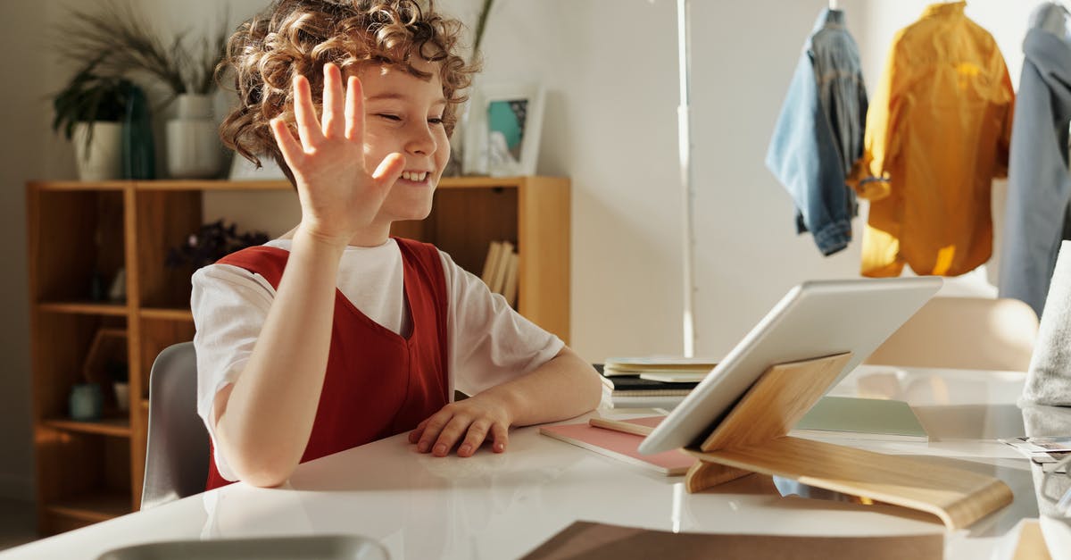 Studying in US under J1 Visa, also have current ESTA, can I stay after grace period using ESTA? [closed] - Photo of Child Smiling While Using Tablet Computer