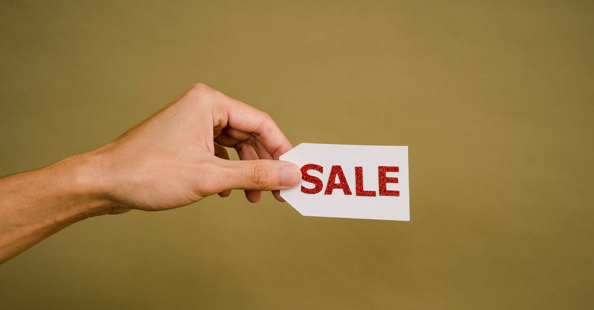 Sudden cheap travel? - Crop faceless person demonstrating sign Sale Sudden cheap travel? - Crop faceless person demonstrating sign Sale