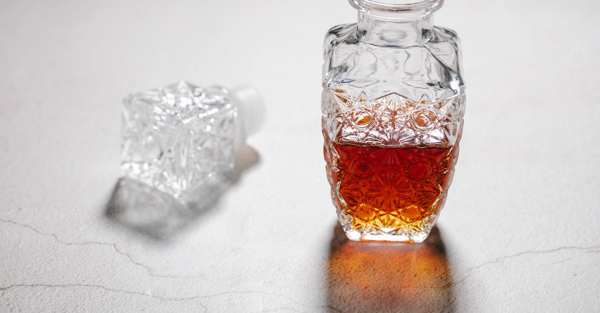 Suitcases: hard or soft? Canvas, polycarbonate or something else? - From above of open crystal glass jug with alcoholic beverage placed on white table with cracks Suitcases: hard or soft? Canvas, polycarbonate or something else? - From above of open crystal glass jug with alcoholic beverage placed on white table with cracks