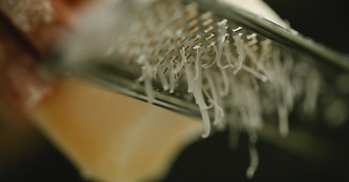 Suitcases: hard or soft? Canvas, polycarbonate or something else? - Crop unrecognizable chef grating delicious cheese on narrow stainless grater in dark kitchen Suitcases: hard or soft? Canvas, polycarbonate or something else? - Crop unrecognizable chef grating delicious cheese on narrow stainless grater in dark kitchen