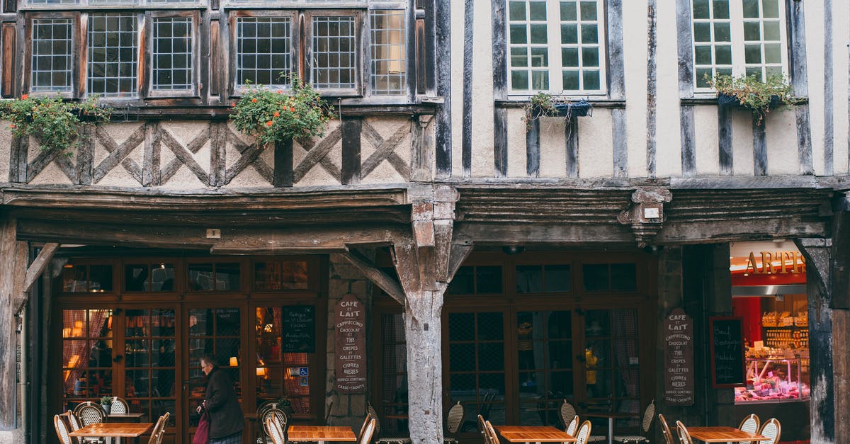 Sunbathing naked in public parks in Germany - Exterior with authentic stone building with outdoor cafe