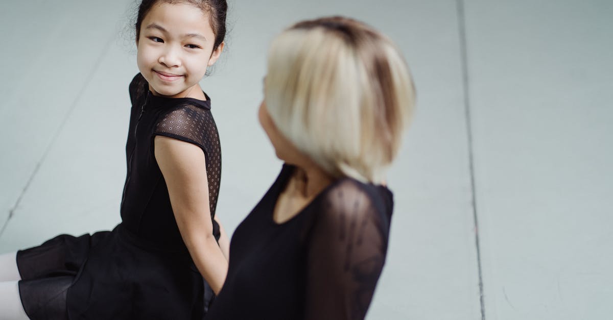 Swap places in business class with friend [duplicate] - From above side view of charming content ethnic pupil in ballet uniform looking at female trainer in hall