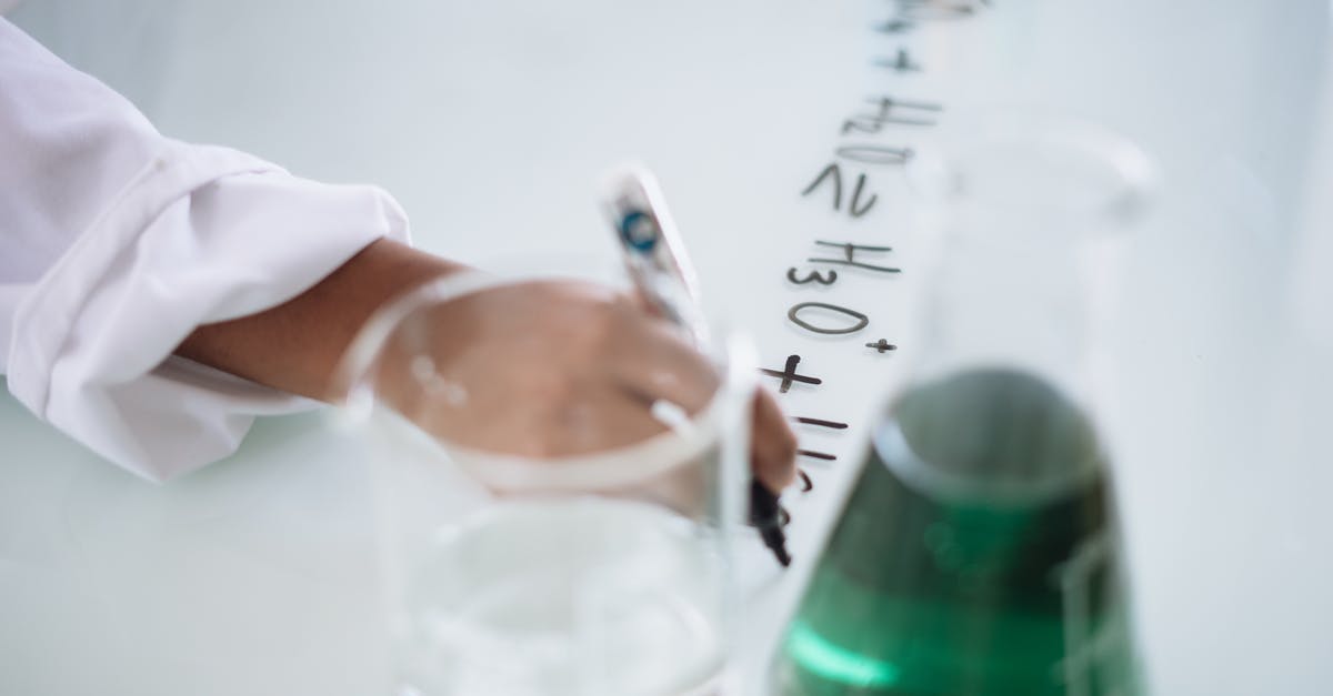 Take test or obtain result 72 hours before arrival? (Flying to Lithuania) - Body part of unrecognizable scientist in white uniform writing down formula after providing chemical research with fluid in flask during science lesson in university