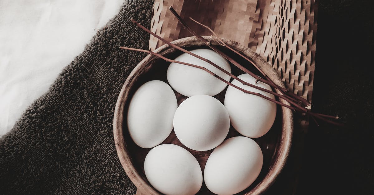 Taking dried food into another country through customs - From above of eggs in wicker bowl with branches placed on paper above towel