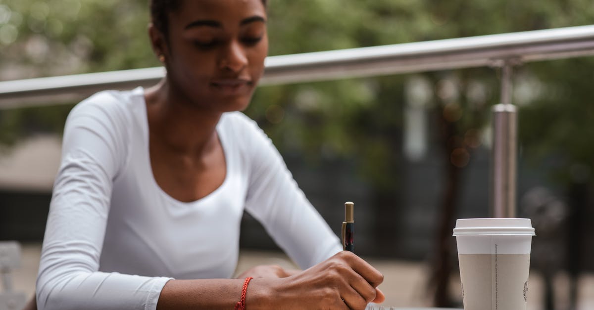 Taking fennel tea bags into Canada - Black woman with coffee and pen on terrace Taking fennel tea bags into Canada - Black woman with coffee and pen on terrace